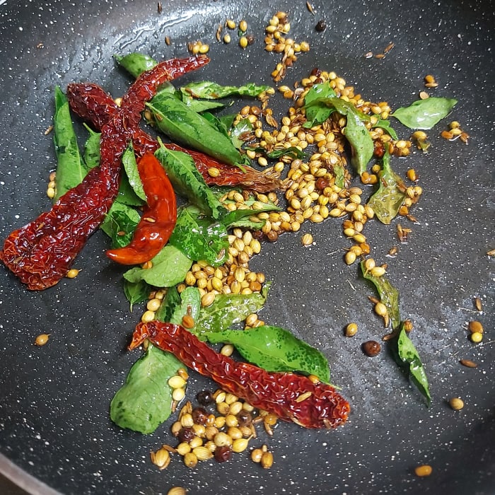 Add 3-4 dry red chilies and 1-2 springs of fresh curry leaves. Saute till the red chilies turn crisp. (I used guntur red chilies to give spiciness and byadagi red chilies to give color). Switch off the heat.
