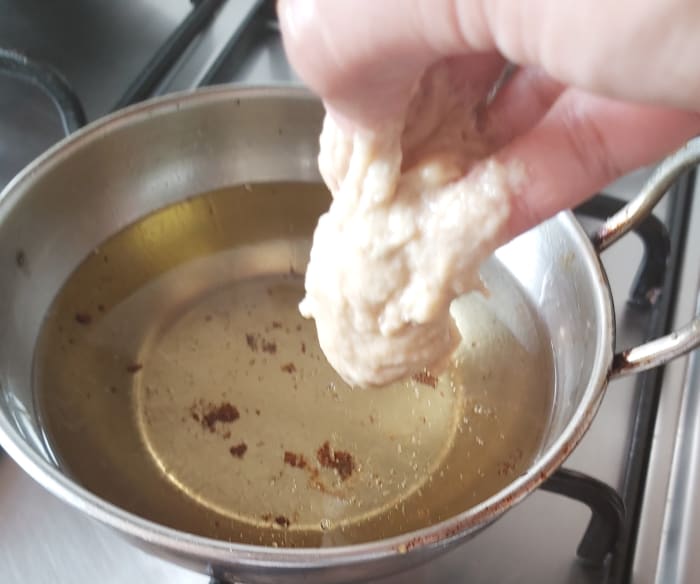 Once hot, scoop out a small portion of batter in your hand and drop it into the oil (no need to form a shape).