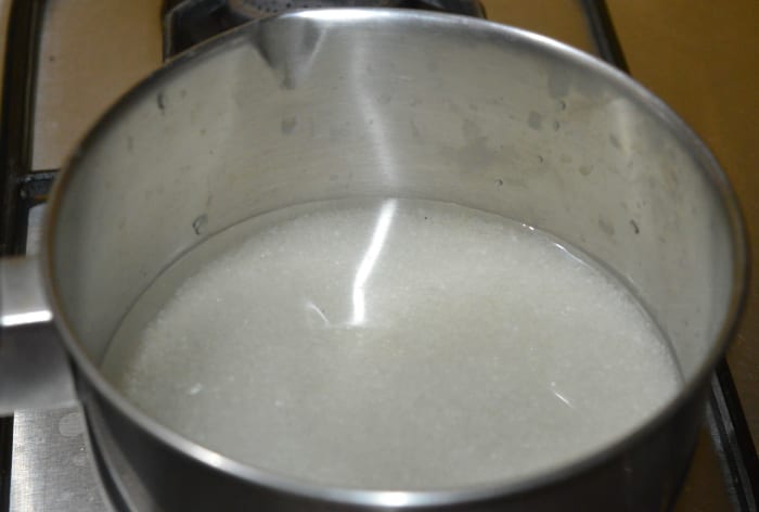 Step two: Add sugar and water to a deep-bottomed pan. Make sugar syrup as per instructions. Add cardamom powder. Boil the sugar syrup until you get single-string consistency. Boil for one more minute. Turn off heat.