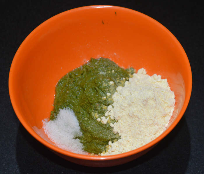Step three: Transfer the paste to a mixing bowl. Add chickpea flour (besan) and salt. Add 2 tablespoons of water and mix well.