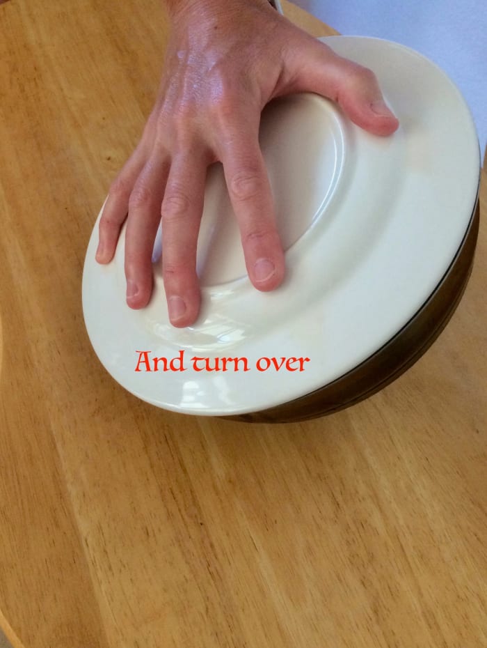 Turn the mixture onto the plate. The frittata will be upside-down. Slide the frittata back into the pan and continue to cook. The cooked side will now face up.