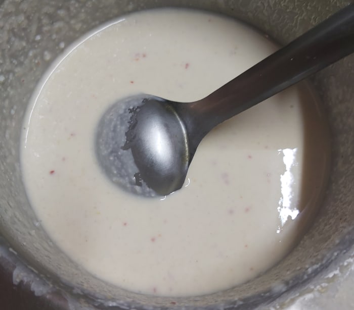 Add 1/2 teaspoon of baking soda and mix well. Add more water if required to make the batter flowing consistency (batter should not be very thick nor too watery).