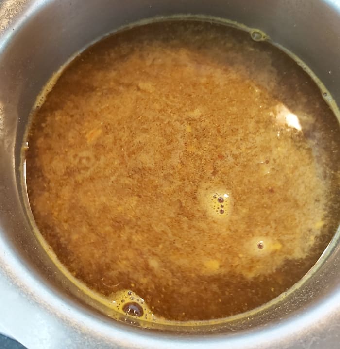 Let it come back to the boil and boil for 1-2 minutes over low heat till the raw smell of tamarind disappears. Switch off the flame.