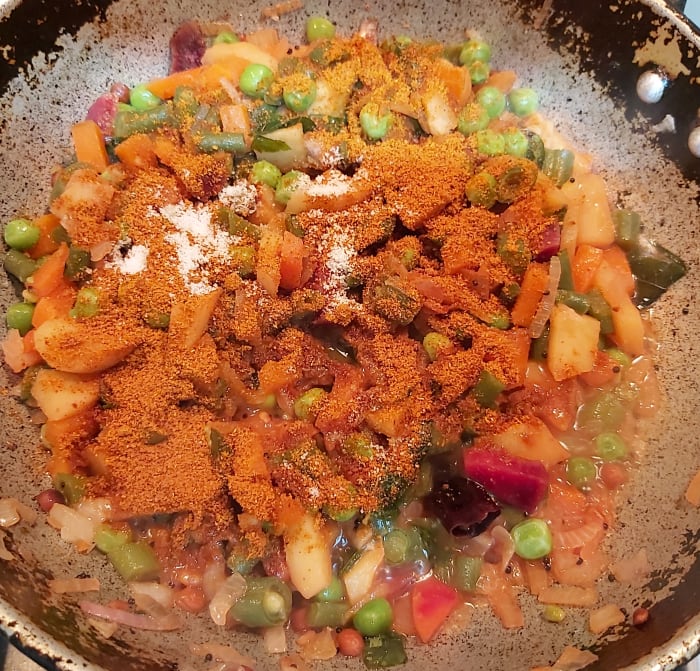 Add 2-3 teaspoons of sambar powder (I used store-bought sambar powder, you can use homemade, too) and salt to taste (vegetables are cooked with salt, so add salt sparingly).