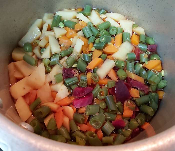 When the pressure of the cooker releases naturally, open the lid. Vegetables should be cooked well by now.