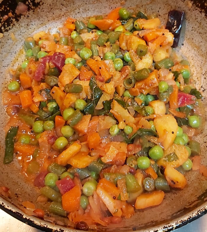 Cook till raw smell of sambar powder goes away and all water dries up (if any). Switch off the heat.