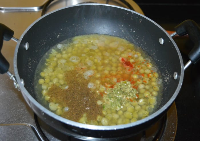 Heat the pan. Add ginger-green chili paste, garam masala powder, red chili powder, and remaining salt.
