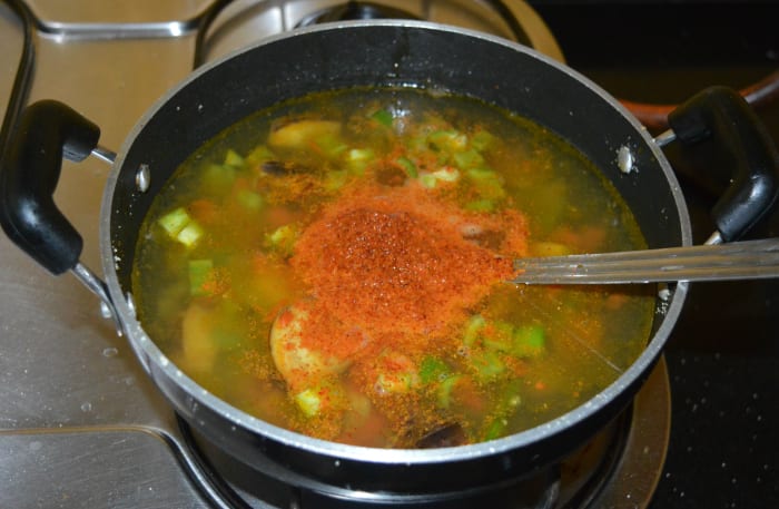Step five: Add about 8 cups of water, vangibath powder, remaining salt, and sugar. Let the mixture come to a gentle boil. Add the roasted semolina little by little so that it won't form lumps. Stir it continuously until the semolina mixes well.