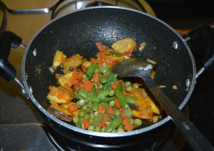 Step four: Add the parboiled veggies. Mix it properly with the other ingredients in the pan. Continue to cook for a minute.