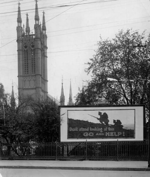 A recruitment poster outside a church in Toronto, Canada, 1914. The message is direct: Don't stand looking at this: GO and HELP!