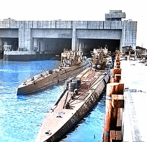 World War II: A smaller Type VII U-Boat (left) next to a large Type IX U-Boat in the submarine pens at Trondheim, Norway after the war. U-864 was a Type IX.