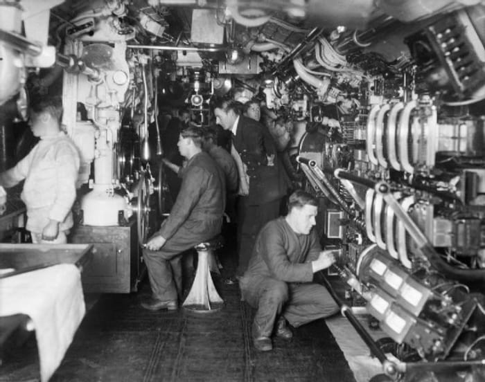 World War One: Interior of a British E-Class submarine. Officer supervising submerging operations.