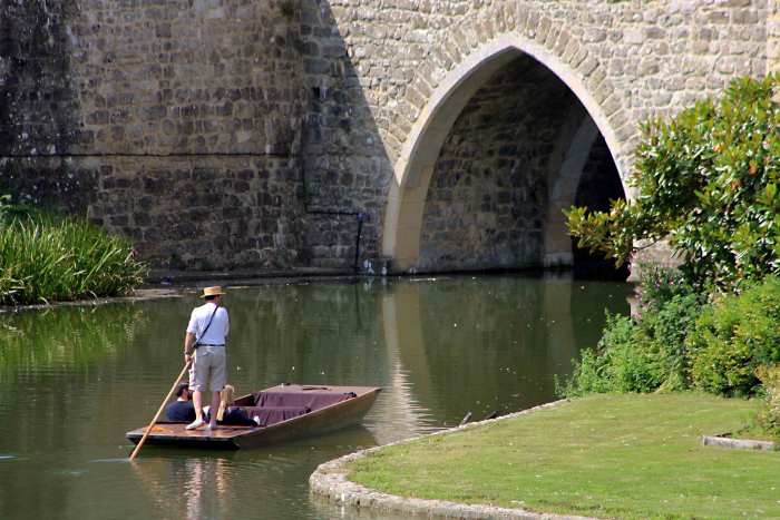 One can view the castle from the tranquility of a punt - a guide navigates the punt on a 20 minute tour around the moat