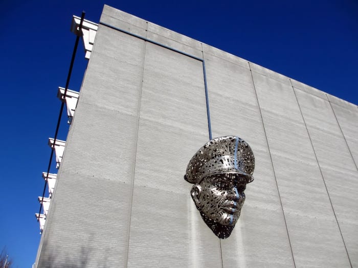"Thin Blue Line" by Michael Stutz. Located in Richmond Virginia in the Monroe Ward District. This piece is a 1,200 lbs stainless steel art installation to symbolize the humanity of the Police Department; however, at the same time to show sternness.