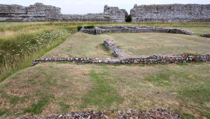 The foundations of town buildings dating from 100 AD - 250 AD. These are believed to be houses and shops. On the left is one of the 3rd century trenches constructed as Rutupiae returned to its fortress status