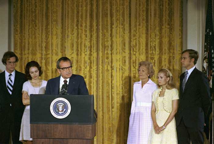 President Richard Nixon delivers remarks to the White House staff on his final day in office. From left to right are David Eisenhower, Julie Nixon Eisenhower, the president, First Lady Pat Nixon, Tricia Nixon Cox, and Ed Cox.