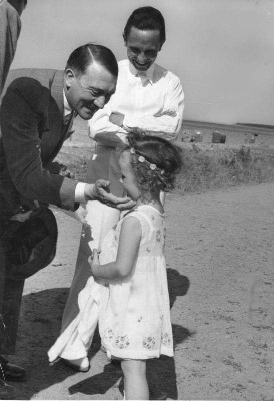 This uncharacteristic photo of Adolf Hitler reveals a side of him that is often not presented. Here he is talking to his good friend Joseph Goebbel's daughter. Hitler had a very charismatic presence, despite most photos showing a very severe man.