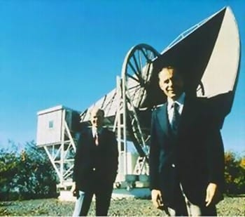 A photograph of Arno Penzias and Robert Wilson standing next to a radio telescope