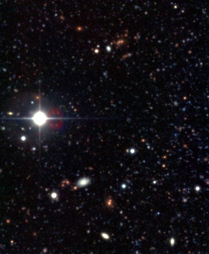 A cluster of galaxies from NGC 300 images. Their red color suggests they are equidistant from each other.