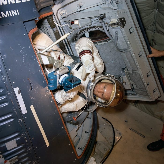 Astronaut Buzz Aldrin, Prime Crew pilot of the Gemini XII space flight, undergoes zero-gravity ingress and egress training aboard an Air Force KC-135 aircraft. He practices using camera equipment.