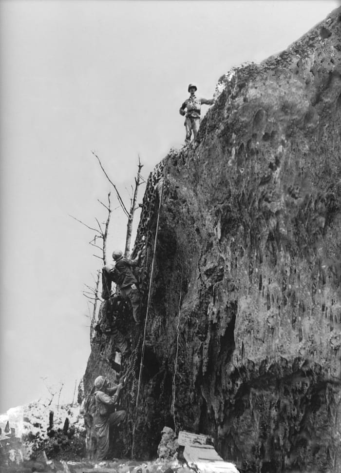 Picture of Doss atop Hacksaw Ridge. It is here that Doss lowered over 75 injured soldiers down to safety.