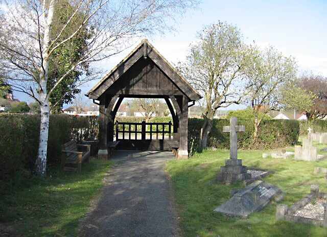 A lych gate is a gateway with a roof found at the entrance to a churchyard. This lych gate is located in Great Shelford.