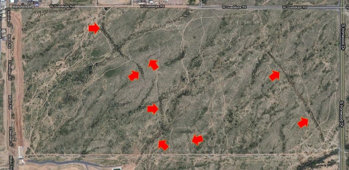 The red arrows indicate locations of earth fissures. This area is located in central Arizona in the eastern outskirts of Phoenix.