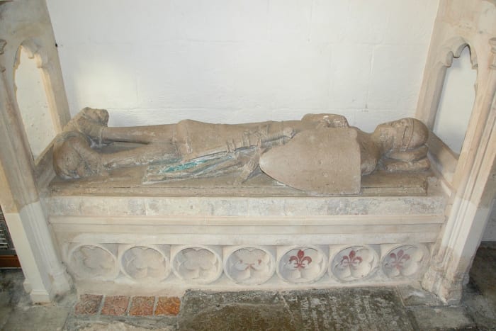 Fleurs-de-lis at the bottom of the tomb of Robert FitzElys in St. Mary the Virgin Parish Church, Waterperry, Oxfordshire; the fleurs-de-lis are the red drawings on the right of the tomb