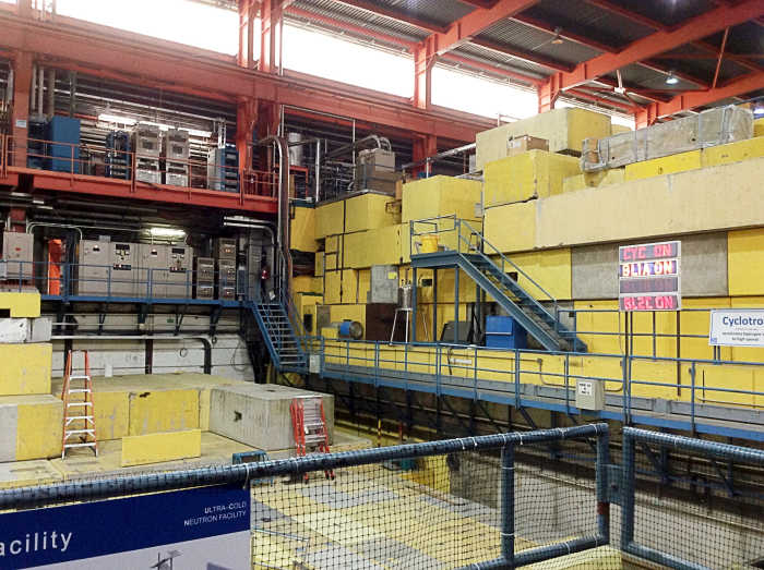 The tall stacks of staggered blocks cover the roof of the cyclotron vault and absorb radiation. The lights indicate that the cyclotron and two beam lines are operational.