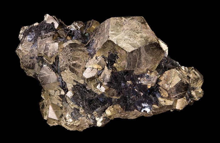 Pyrite is comprised of iron (Fe) and sulphur (S) and often forms cuboidal crystals, as pictured above.