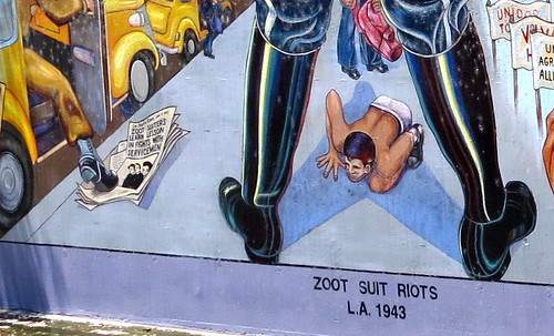 The newspaper headline reads "Zoot suiters learn lesson in fights with servicemen."