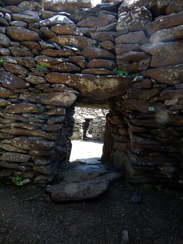 Inside one of the larger Fahan structures. This Clochán is made of three interconnected huts and contains a fire pit.