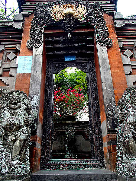 Above top and bottom: Elaborate carvings and stone statues guarding the gates at these family compounds.