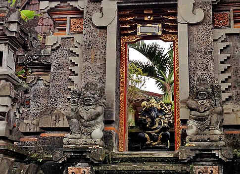 Above top: Two types of gates - paduraksa (left) and candi bentar (right). Above bottom: Stone carvings cover the door frame of this paduraksa gate.