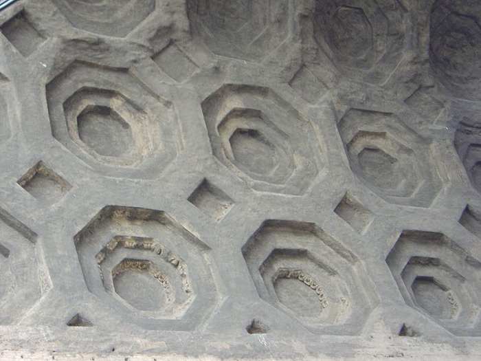 The Romans invented concrete by mixing their lime based mortar with pebbles, fragments of stone and pottery. As can be seen here in the vaulting of the Roman building, the new material allowed an expansion in architectural design.