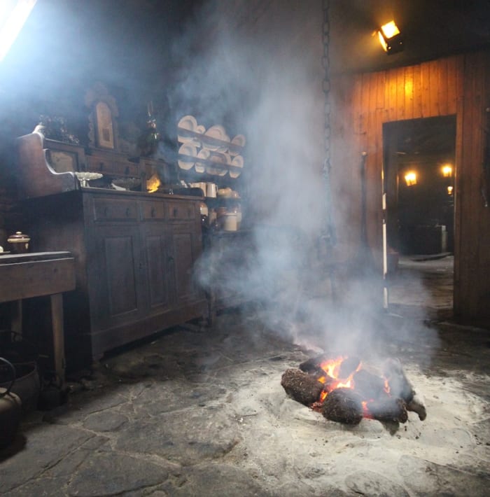 Celtic Blackhouses kept large peat fire in the center of the home.The smoke dissipates out through the thatched roof without a chimney. Photo by Nessy-Pic on WikiCommons.