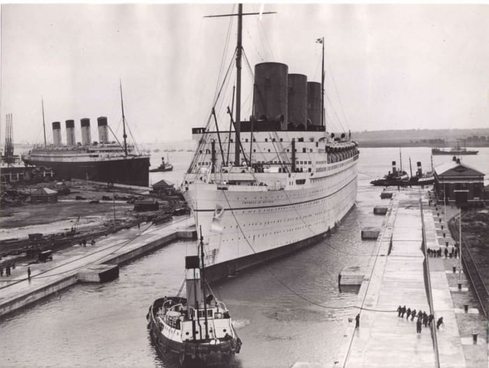 1930s. RMS Olympic behind RMS Empress of Britain, one of the newer, larger, more modern liners Titanic's sister began loosing money to by this time.