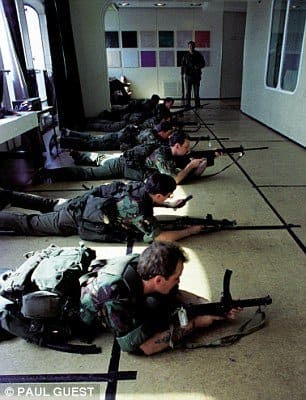 Troops train in one of QE2's converted lounges. Notice how the carpet has been covered over with hardboard.