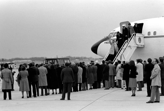 Freed Americans held hostage by Iran disembark Freedom One, an Air Force VC-137 Stratoliner aircraft, upon their arrival at the base. January 27, 1981.