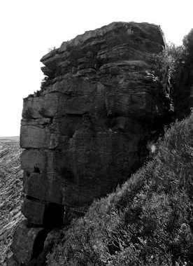 Ponden Kirk is thought to be the location for Penistone Crags and is about one kilometer north of Top Withens. A hole in its base corresponds to the Fairy Cave.