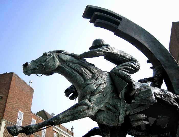 Outside the Ebbisham Centre. Bronze sculpture by Judy Boyt, 2001. It is a portrait of two racehorses, Diomed, the winner of the first Derby in 1780, and on the 2001 winner, Galileo.