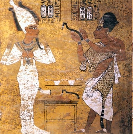 Ay performing the opening of the mouth ritual on Tutankhamun. Tutankhamun is shown here as a fully-fledged Osiris.