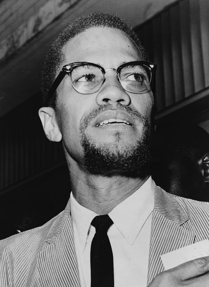 Malcolm X in 1964, shortly after his conversion to Sunni Islam and pilgrimage to Mecca. The trip altered his views. He changed his ideas on political violence. He decided that racial differences could be resolved through Islam.