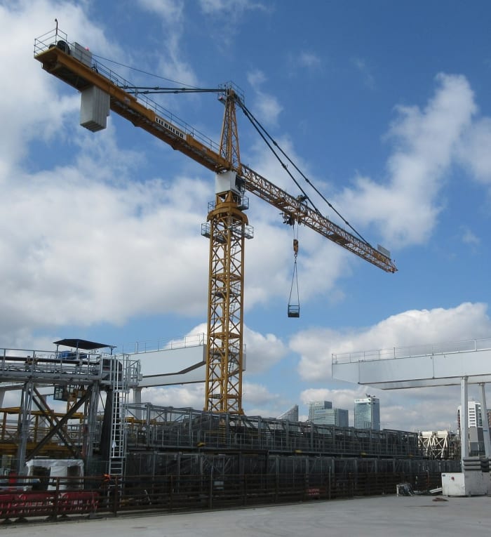 A tower crane. The counterbalance consists of a collection of concrete slabs mounted near the end of the boom.