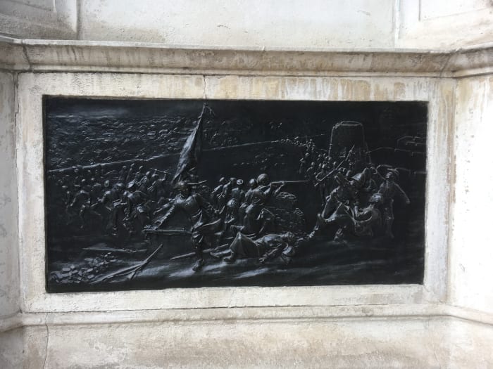 Bronze relief on the memorial showing the Boxer Rebellion - the US Marine figure is seen on the right with the distinct uniform and headgear apart from the Royal Marines