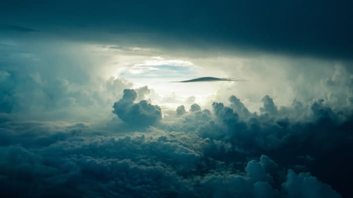 "Caduto dalle nuvole" translates to "fallen from the clouds" and refers to be taken by surprise (as if something had just fallen out of the sky).