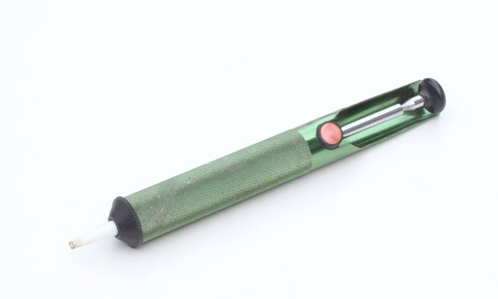 De-soldering pump or "solder sucker" for sucking up molten solder when de-soldering components.