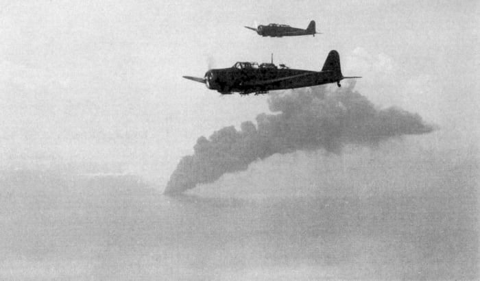 The Japanese airplanes are attacking. The smoke comes from one of the Allied ships, that was sinking.