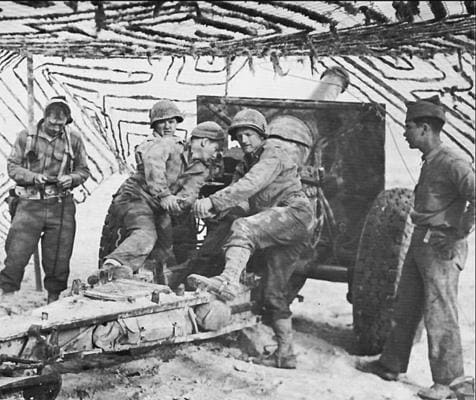 Crew of a 155mm howitzer in North Africa, 1943 (1st ID ner El Guettar). The version of the 155mm they're using was modfied the next year. Most notably, the safety plate was changed. On this version, there were no split trailers.