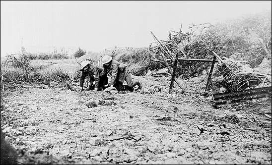 A wounded man from the Newfoundland Regiment is led away from the field by a comrade on the first day of the Somme.